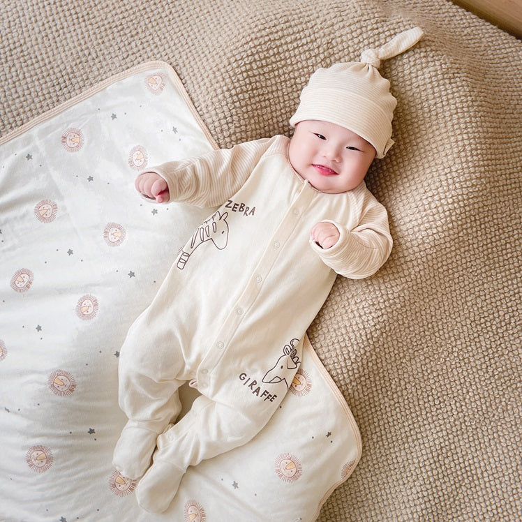 Luxury Baby Gifts - footie romper & beanie on baby model | Eotton Canada
