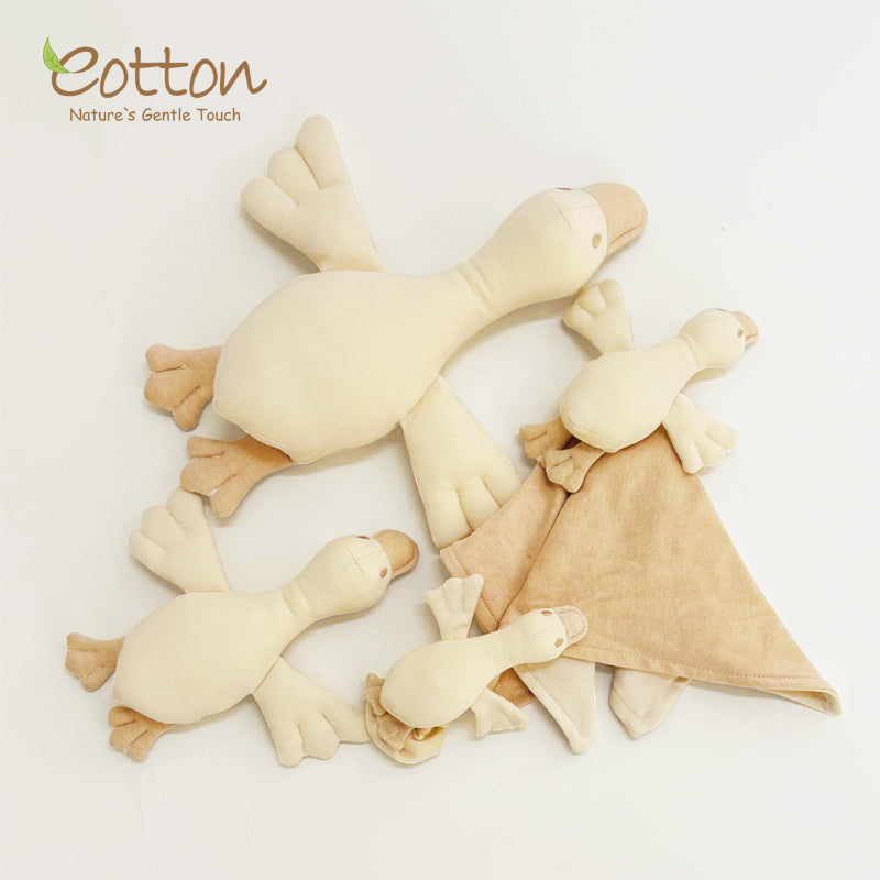 organic white goose rattle for baby wrist and ankle wearing in a minimalist cream design | Eotton Canada