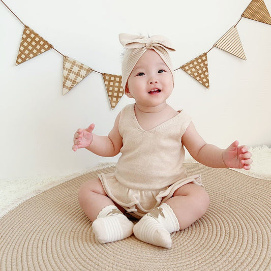 Organic Knitted Sweater: Baby Girl Cable Knit Ruffler Onesie on Baby model | Eotton