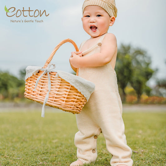 A curated gender neutral baby gift box featuring organic cotton clothes and a white goose toy for a newborn shower gift