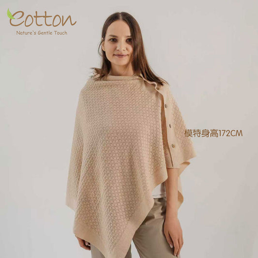 A mother wearing the Eotton Canada 4-in-1 organic cotton knitted nursing cover configured as an elegant cream cloak poncho | Eotton Canada