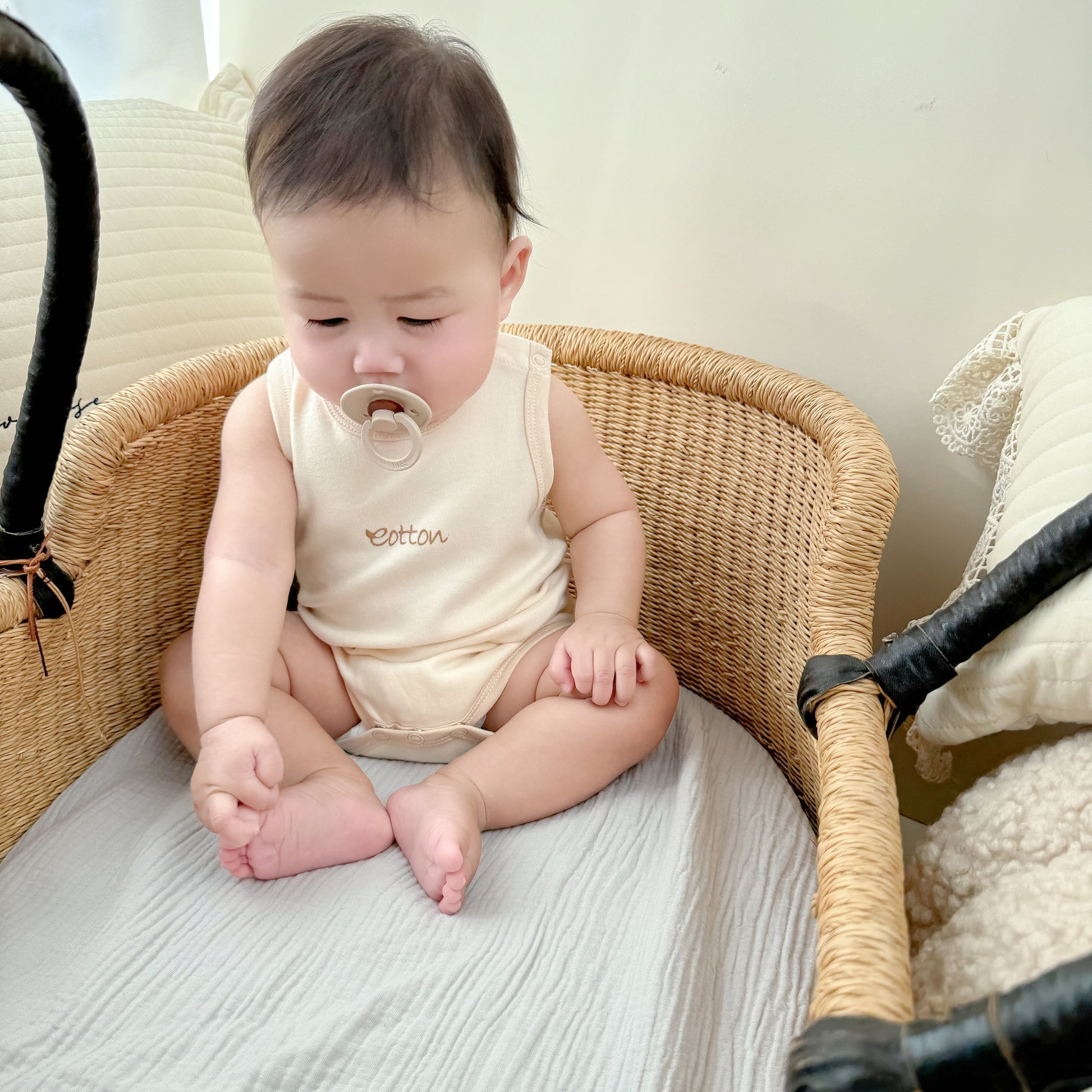 Softest baby short bodysuit in cream, made of certified organic cotton for summer 