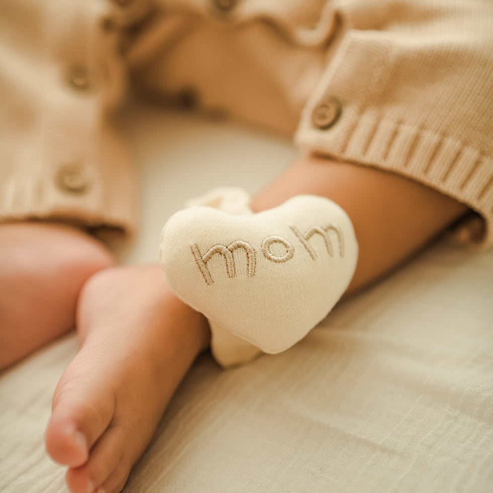 organic baby ankle rattle used as foot finder toy on infant leg