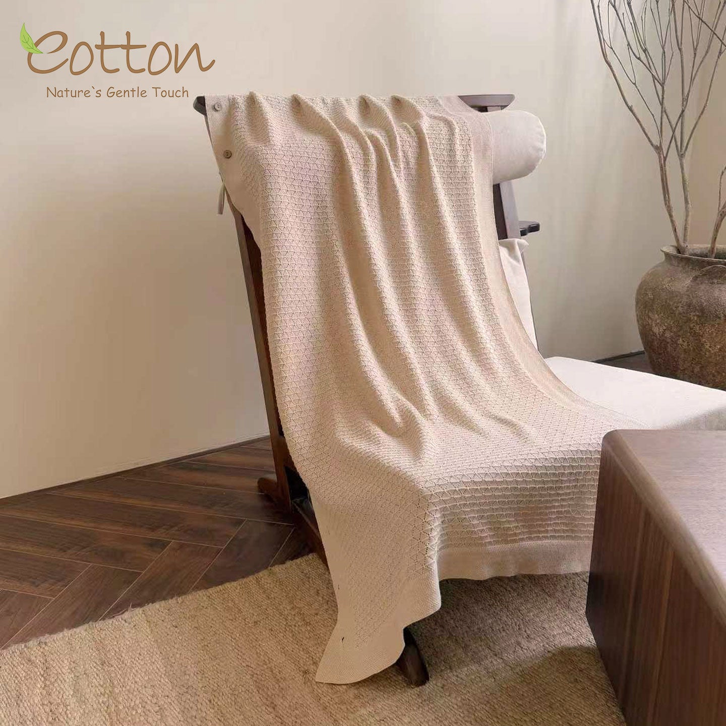 The unbuttoned organic baby blanket opened flat over a chair, highlighting its premium breathable texture for use as a stroller or car seat canopy