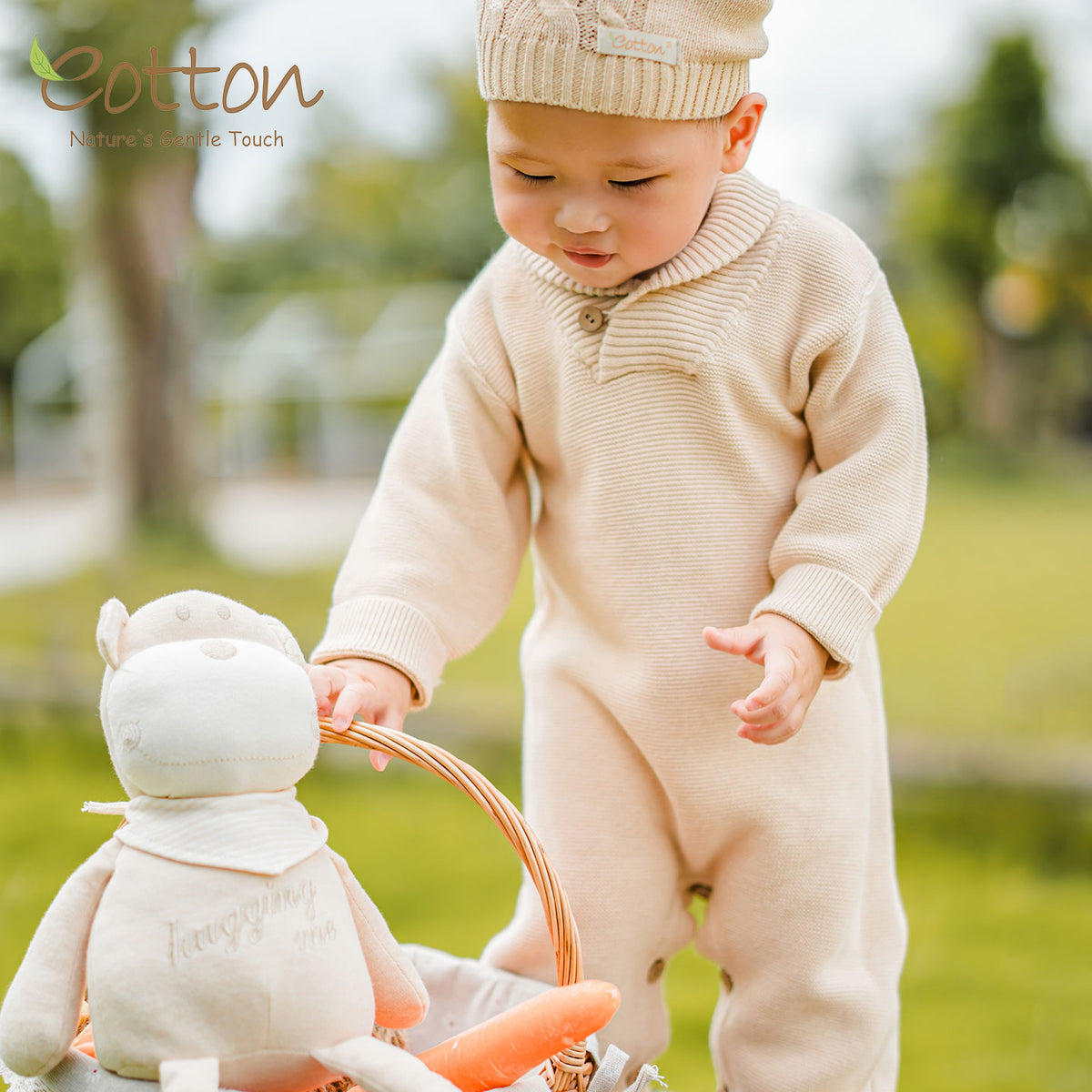 Baby wearing an organic cotton cable knit romper by Eotton
