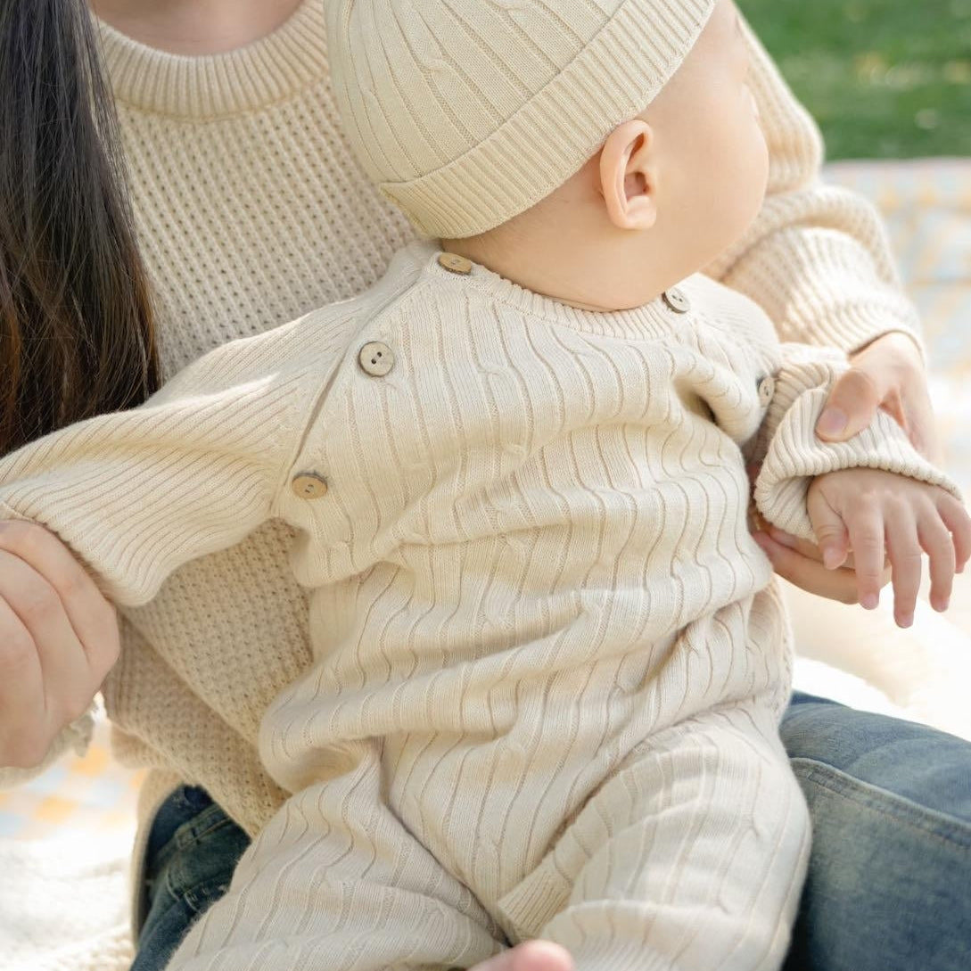 Lightweight organic cotton mini cable knit baby romper in natural color cotton for newborn summer wear