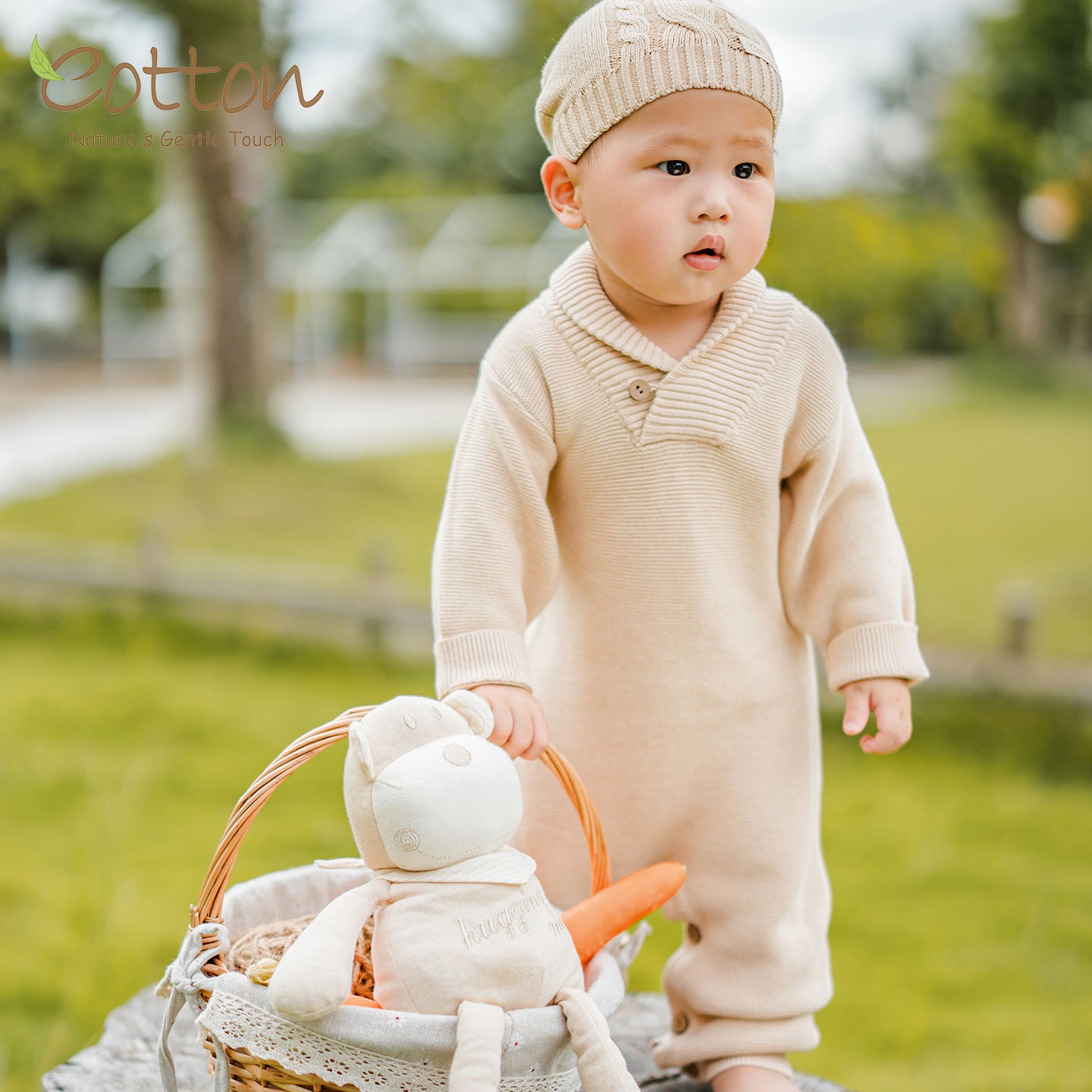 Organic cotton cable knit baby romper in natural cotton color