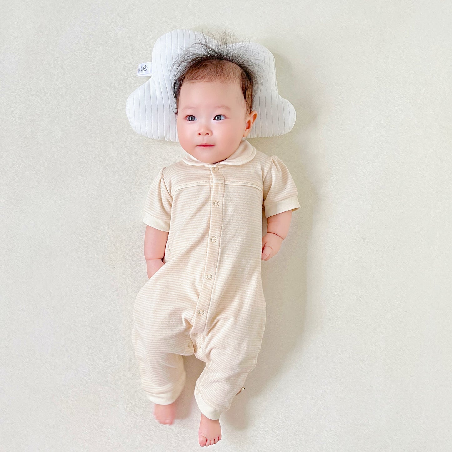 Organic baby girl short sleeve romper with a white Peter Pan collar in solid nature colored cotton