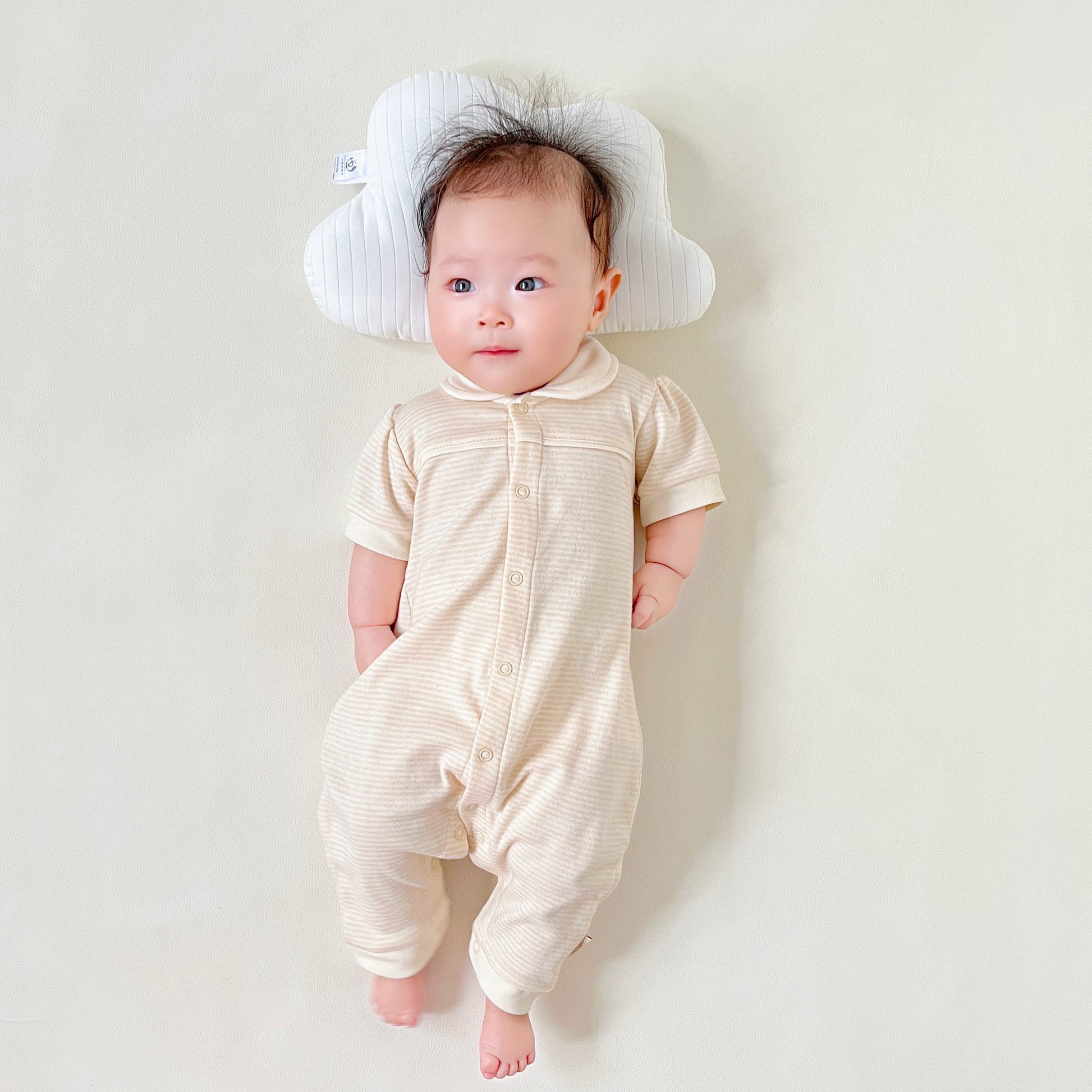 Organic baby girl short sleeve romper with a white Peter Pan collar in solid nature colored cotton