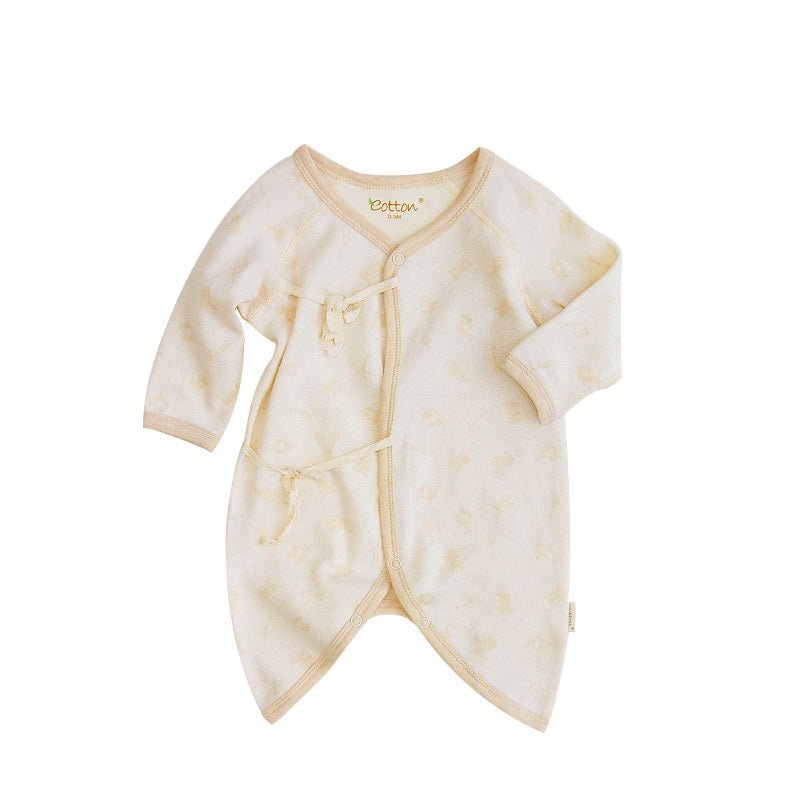 Close up view of the adjustable side rope closure on a wrap style kimono newborn romper showing the soft stitching
