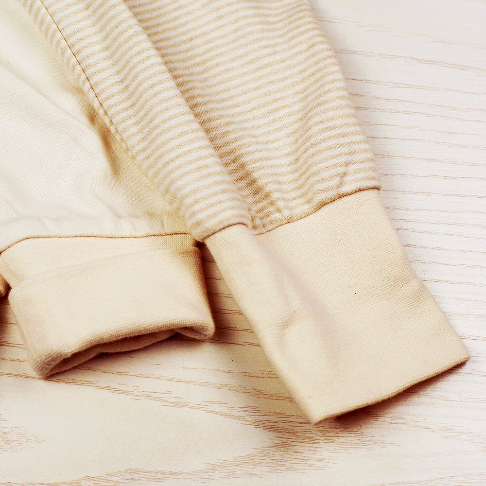 Close up look at the stretch cuffed organic cotton baby pants detailing the soft knit ankle weave.