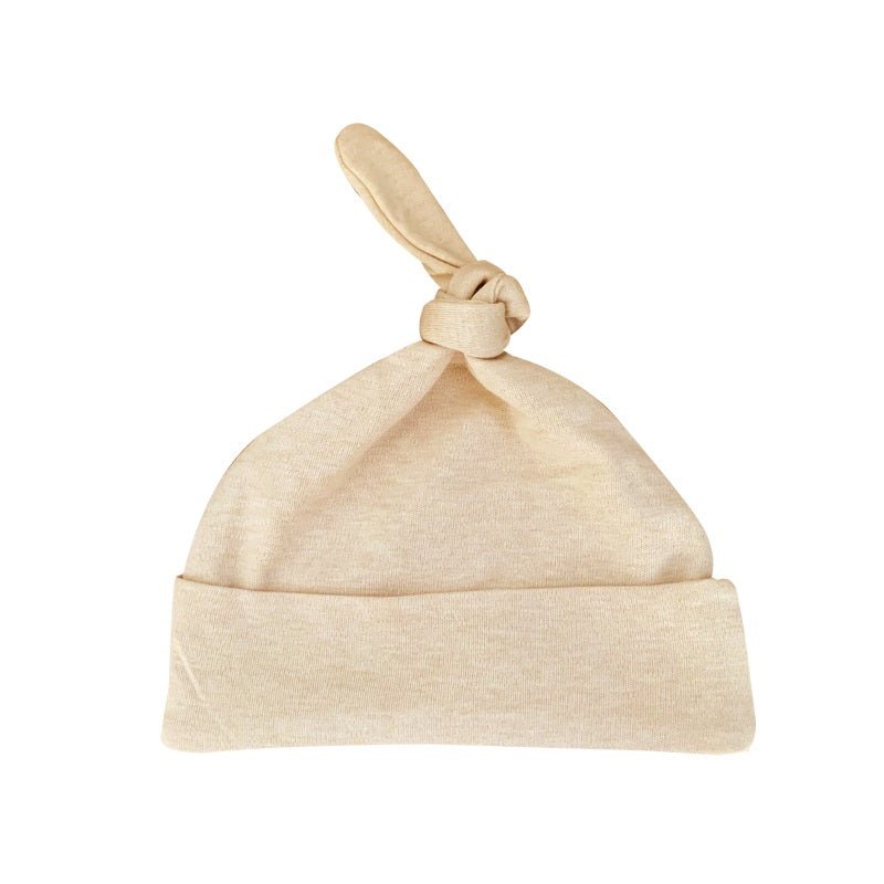 Solid earth tan baby hat showing the soft stretch knit foldover brim on a certified nature colored cotton top knot cap | Eotton Canada