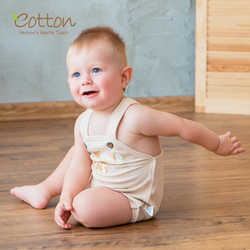 Premium gender neutral baby bodysuit and organic summer onesie featuring adjustable straps with coconut shell buttons.
