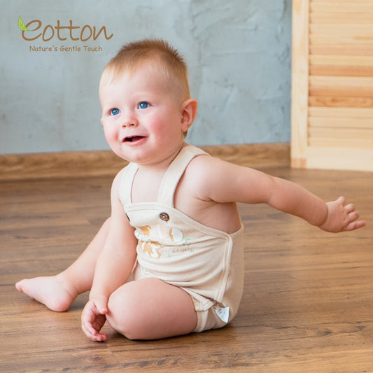 Premium gender neutral baby bodysuit and organic summer onesie featuring adjustable straps with coconut shell buttons.