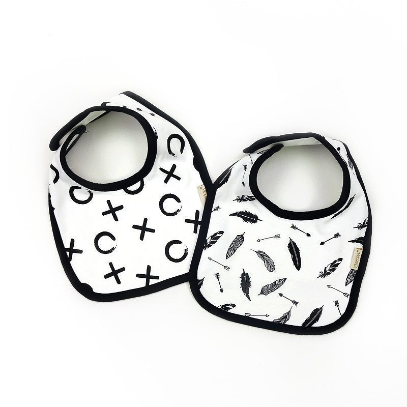 Flat lay view of the black organic cotton infant drool bib featuring a high contrast white feather accent design
