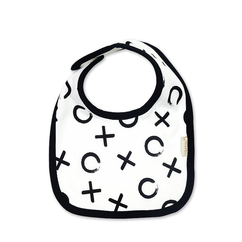 Close up view of the white organic baby bib adorned with the minimal black XOXO graphic pattern.