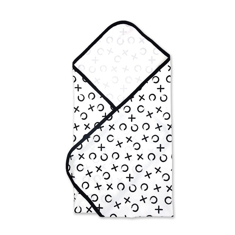 Oversized monochrome newborn swaddle blanket featuring a bold black and white abstract X and O graphic print layout.