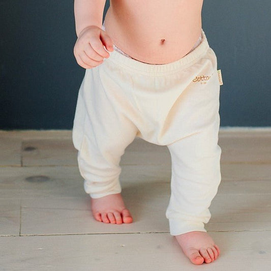 Organic baby harem pants displaying the extra loose diaper room and soft stretch elastic waist.