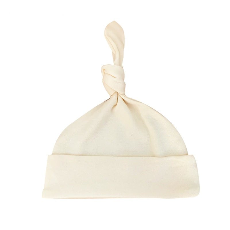 Unbleached ivory organic baby hat featuring an adjustable top knot design in soft combed cotton knit fabric | Eotton Canada
