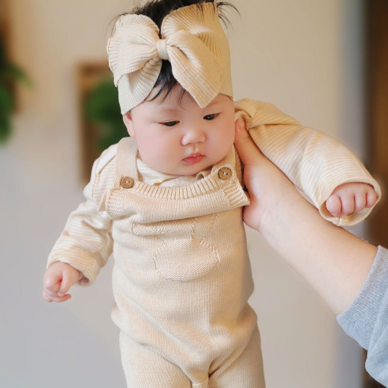 Close up of adjustable straps and cable knit texture on organic baby salopettes | Eotton Canada