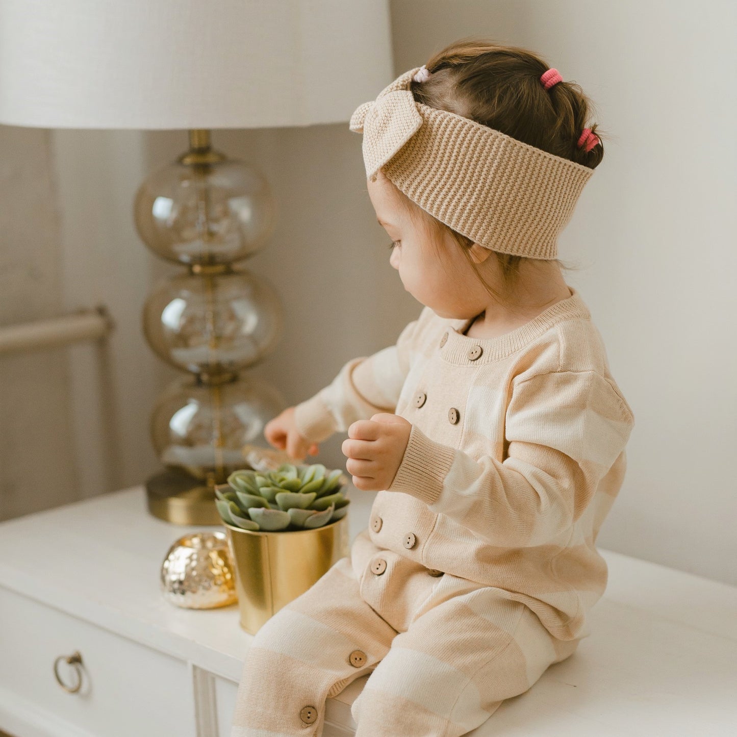 Organic baby spring knitted romper featuring a classic Breton wide stripe pattern and long sleeves | Eotton Canada