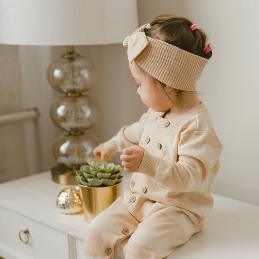 Organic baby spring knitted romper featuring a classic Breton wide stripe pattern and long sleeves | Eotton Canada