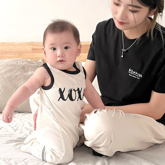 High contrast organic baby tank romper featuring bold black graphics on a nature white combed cotton body | Eotton Canada