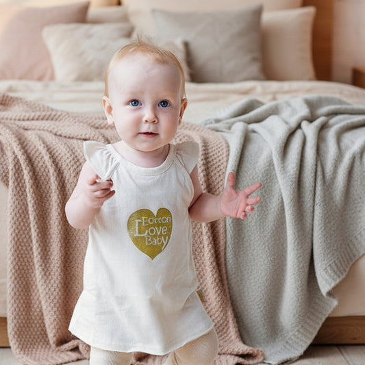 Baby wearing an organic ruffle bodysuit, providing a gentle touch for sensitive newborn skin