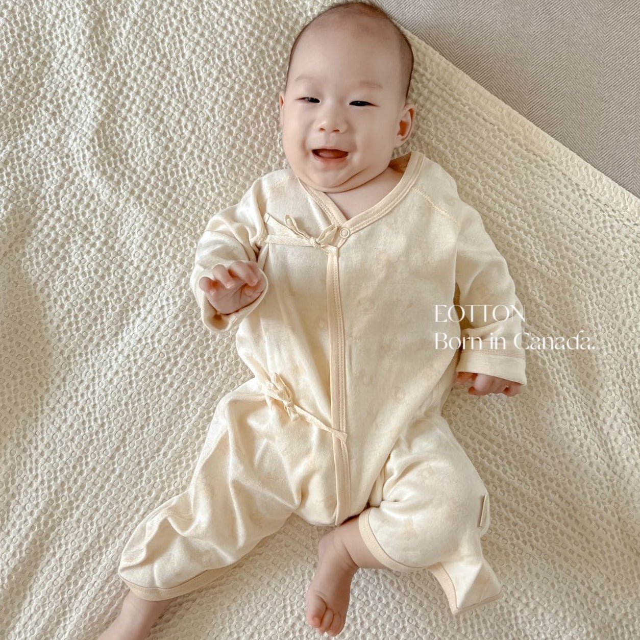 Organic Japanese kimono romper with an adjustable side rope closure in certified nature colored cotton safari animals jacquard pattern