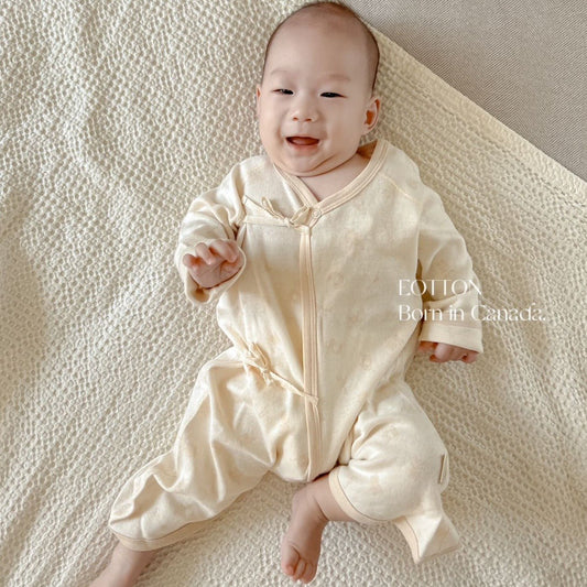Organic Japanese kimono romper with an adjustable side rope closure in certified nature colored cotton safari animals jacquard pattern