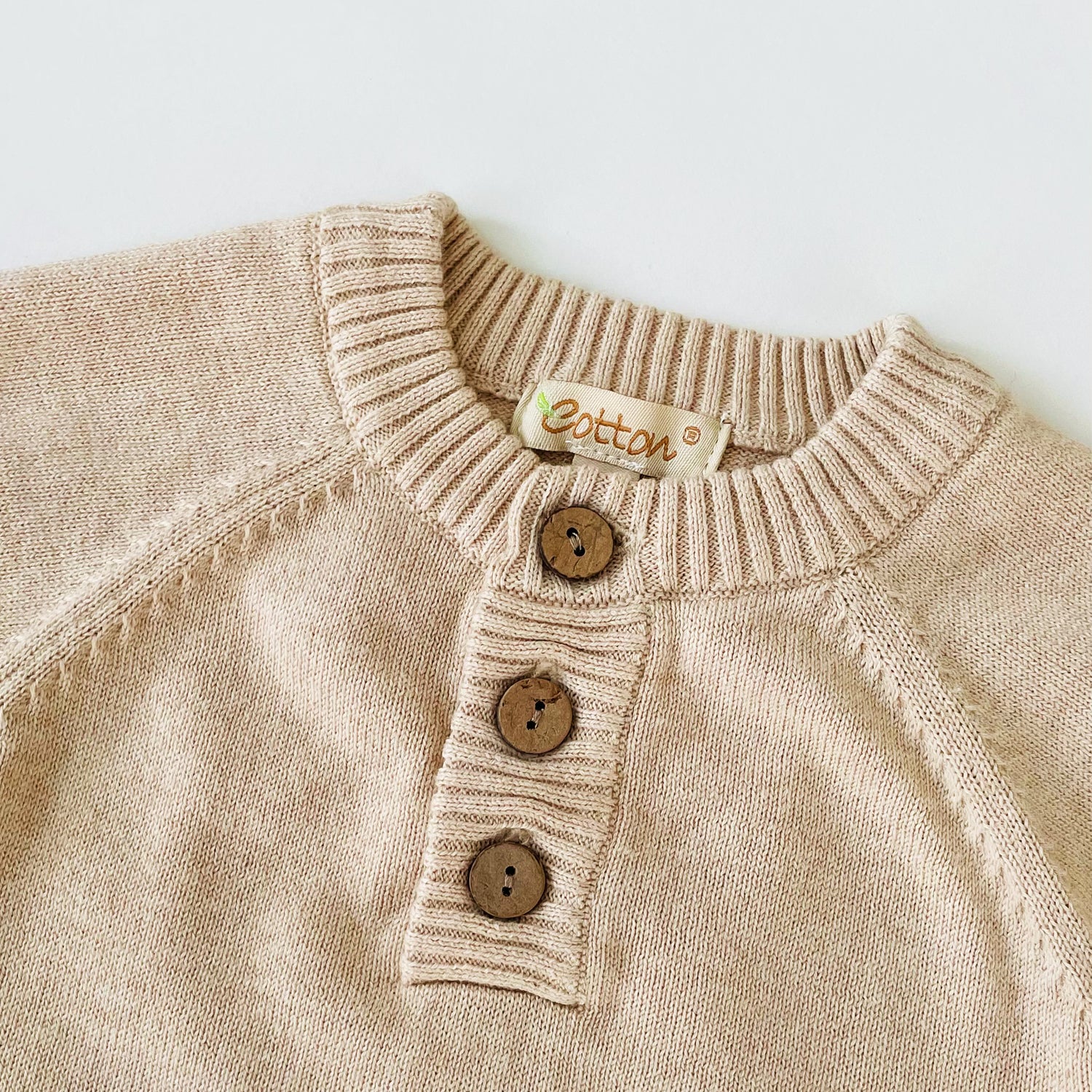 organic cotton baby knitted onesies with coconut shell buttons