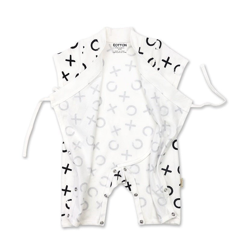 Close up view of the soft interior fabric ribbon ties and flat seams on a silk smooth organic cotton baby wrap suit.
