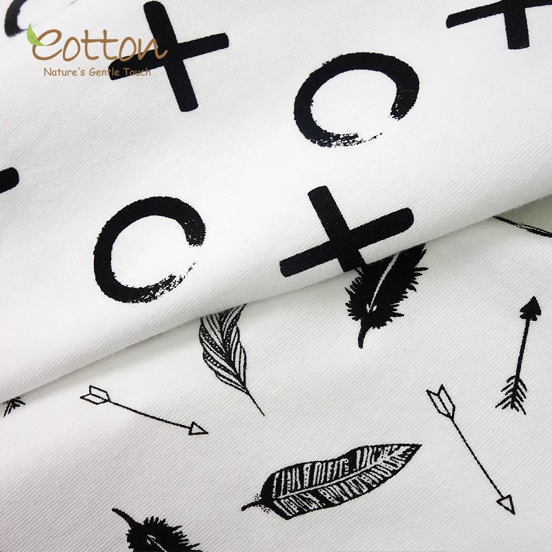 Close up texture view of the silky smooth and stretchy organic combed cotton weave on a black and white infant receiving blanket.