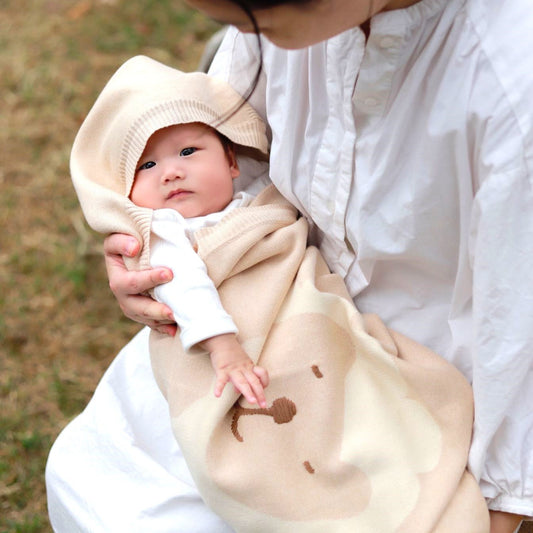 Unique organic cable knit baby blanket with interactive 3D elephant ears and lion tail design | Eotton Canada